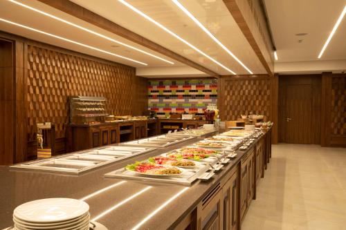 a buffet line with plates of food in a restaurant at ARDEN PALACE Medical Resort & SPA in Satanov