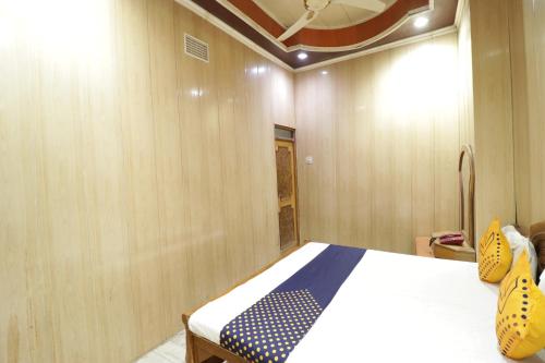 a bedroom with a bed in a wooden wall at Hotel Classic in Lucknow