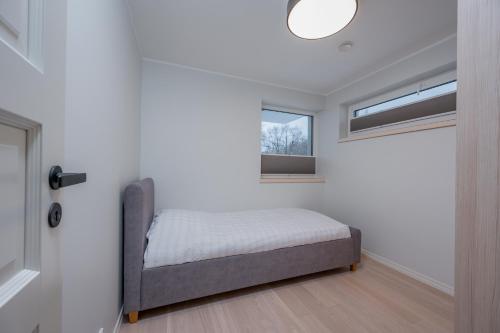 a small bedroom with a bed and a window at Kalda Villa in Kitseküla