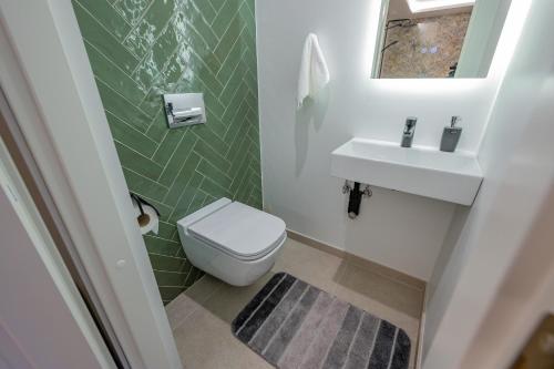 a small bathroom with a toilet and a sink at Kalda Villa in Kitseküla