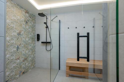 a bathroom with a shower with a glass door at Kalda Villa in Kitseküla