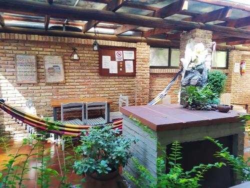 a brick building with a hammock in front of it at BUNGALOWS JAUREGUIBEACH in Jaureguiberry