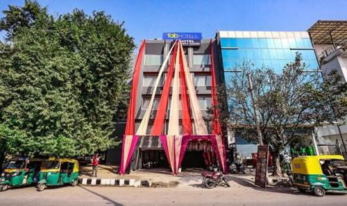 a building with a red structure in front of it at FabHotel Aerosky Grand in New Delhi