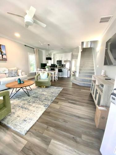 a living room with a couch and a table at Henderson Haven 4 BR / 3 BA Villa, Steps to Beach in Wrightsville Beach