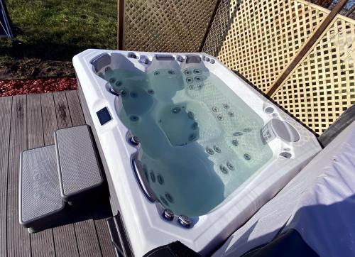 a jacuzzi tub sitting on a deck at Majorka in Tiszafüred