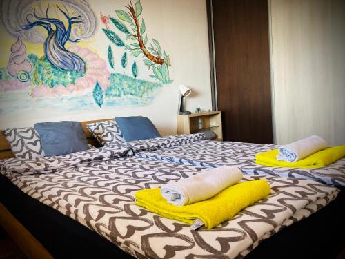 a bedroom with a bed with towels on it at Apartman “Zara” in Zagreb