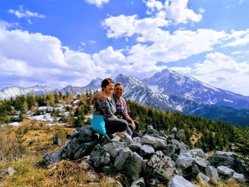 a couple sitting on a pile of rocks on a mountain at Familienbauernhof Imitz, Ferienwohnung in Spital am Pyhrn