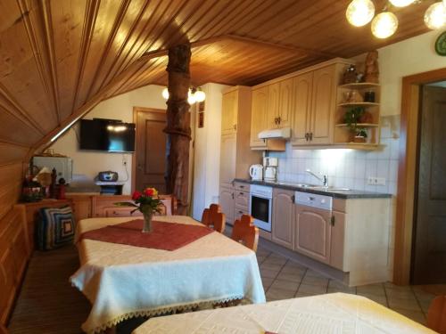 a kitchen with a table with a vase of flowers on it at Familienbauernhof Imitz, Ferienwohnung in Spital am Pyhrn