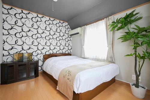 a bedroom with a bed and a potted plant at G48-Superior Room in Shinjuku, Tokyo in Tokyo