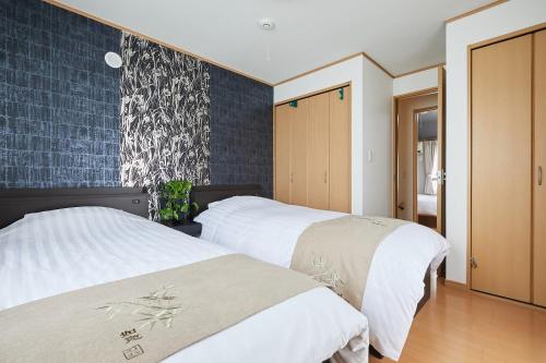 two beds in a room with blue tiles at G48-Superior Room in Shinjuku, Tokyo in Tokyo