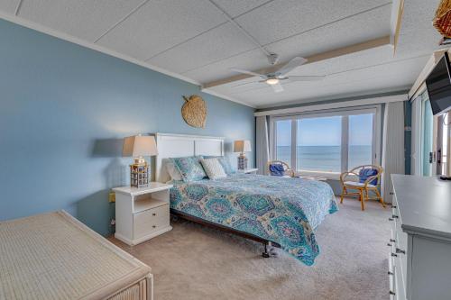 a bedroom with a bed and a view of the ocean at Salty Sands in Ocean City