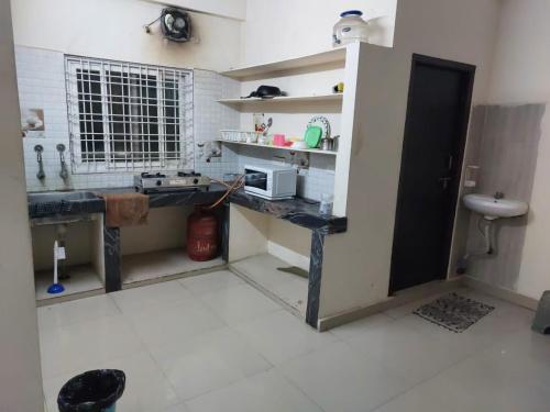 a small kitchen with a counter and a sink at Melody in Hyderabad