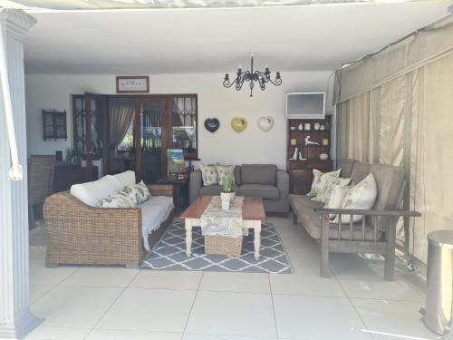 a living room with a couch and a table at Sylvern Bed and Breakfast in Durban