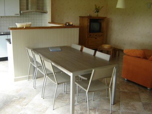 a dining room table and chairs in a kitchen at De Kleen Meulen - max 6pers in Lummen