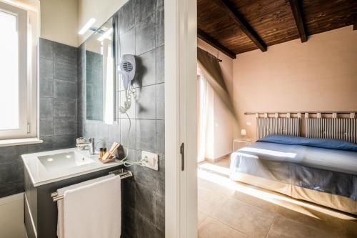 a bathroom with a sink and a bed in a room at Residenza Mistral in Rende