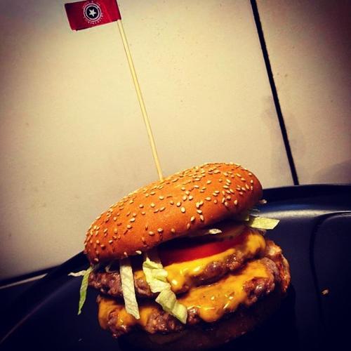 a hamburger with cheese and meat on a bun at Кімнати в центрі з усіма зручностями та окремим входом in Ivano-Frankivsʼk