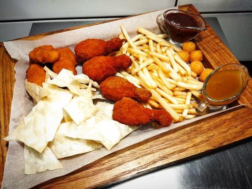 a tray of food with chicken nuggets and french fries at Кімнати в центрі з усіма зручностями та окремим входом in Ivano-Frankivsʼk
