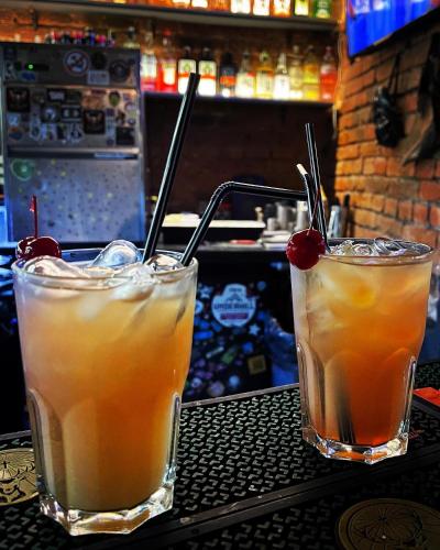 two cocktails sitting on a table in a bar at Кімнати в центрі з усіма зручностями та окремим входом in Ivano-Frankivsʼk