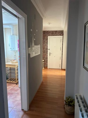 a hallway with a door leading to a room with a table at Cristina Apartamento Center in Valencia