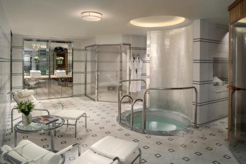 a bathroom with a tub and a table and chairs at The Beaumont Hotel in London