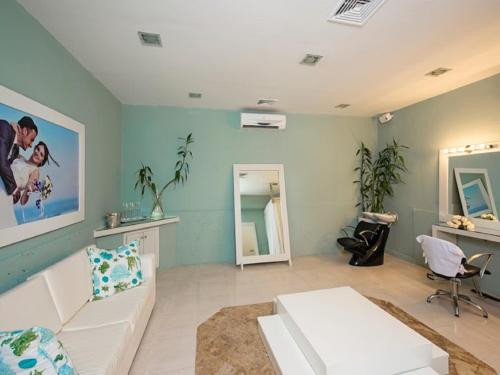 a living room with a white couch and a mirror at Ocean Blue & Sand Beach Resort - All Inclusive in Punta Cana
