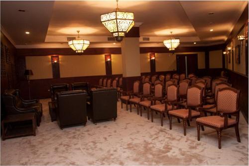 a conference room with chairs and lights and chandeliers at Jewel Sport City and Aqua Park in Cairo