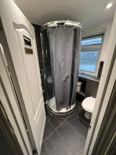 a bathroom with a shower and a toilet at Goodwood Hotel in London