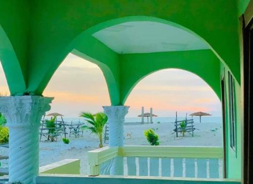 vistas a la playa desde un edificio con un arco en Bosofet Beach and Creek Lodge en Sanyang