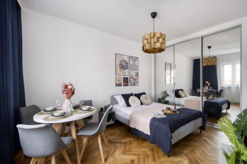 a bedroom with a bed and a table and chairs at Apartments Old Town by Arrenda in Warsaw