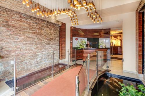 a lobby with a brick wall and a staircase at Hotel Kiwano Graz in Feldkirchen bei Graz