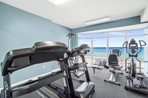 a room with a gym with a view of the ocean at Emerald Isle by Panhandle Getaways in Panama City Beach