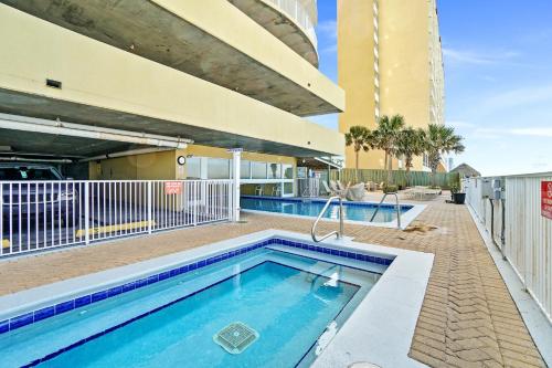 a swimming pool in front of a building at Emerald Isle by Panhandle Getaways in Panama City Beach