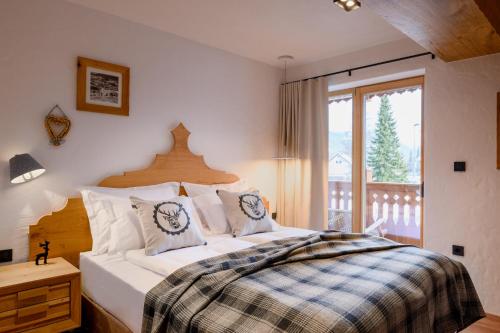 a bedroom with a large bed and a window at Vila Pavlina in Kranjska Gora