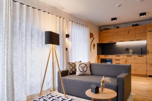 a living room with a blue couch and a table at Vila Pavlina in Kranjska Gora
