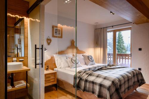 a bedroom with a bed and a sink and a mirror at Vila Pavlina in Kranjska Gora