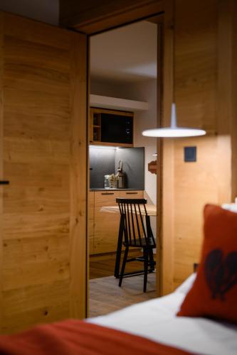 a room with a bed and a table and a chair at Vila Pavlina in Kranjska Gora