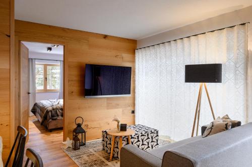 a bedroom with a bed and a tv on a wall at Vila Pavlina in Kranjska Gora