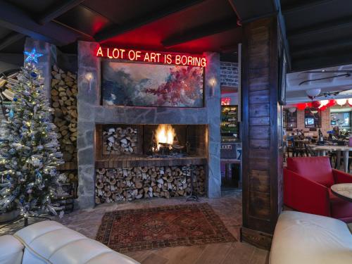 a living room with a fireplace and a christmas tree at Snow Lodge Hotel Courchevel 1850 in Courchevel