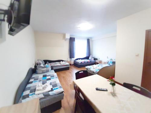 a room with two beds and a living room at HOTEL RADOMSKO in Radomsko