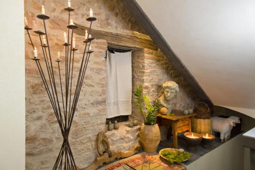 a room with a stone wall and a table with candles at Alodia in Alquézar