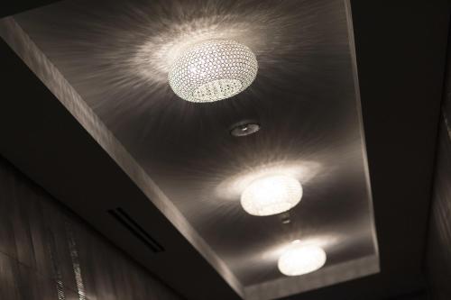 two lights on the ceiling of a room at Liberty Suites in Thornhill