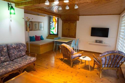 a living room with a couch and chairs and a table at Greece Seaside villa 200sq m 20m from sea in Káto Alepokhórion