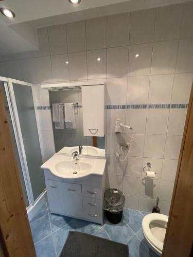a bathroom with a sink and a toilet at Waldrestaurant VIDA in Kapfenberg