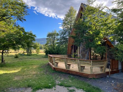 a cabin in the woods with a large deck at CABAÑAS BOSQUE NEVADO in Malalcahuello