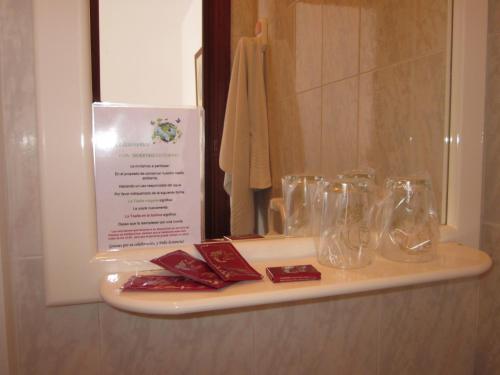a shelf in a bathroom with glasses on it at Habitaciones López Azcona in Noja
