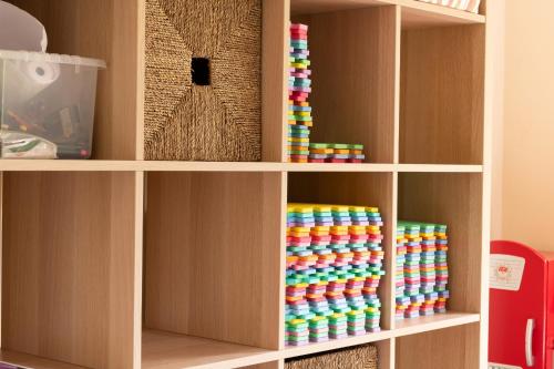 a book shelf with colorful disks on it at Finest Retreats - Bryn Seion in Llanrwst