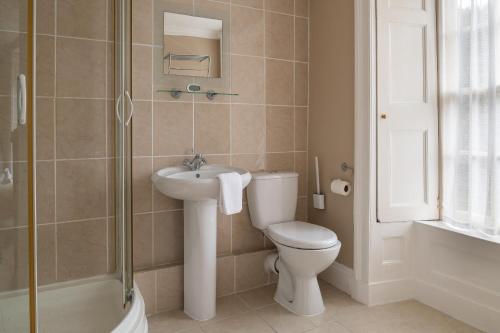 a bathroom with a toilet and a sink and a shower at Finest Retreats - Bryn Seion in Llanrwst