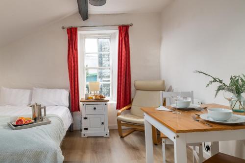 a bedroom with a bed and a desk and a table with a table at Finest Retreats - Bryn Seion in Llanrwst