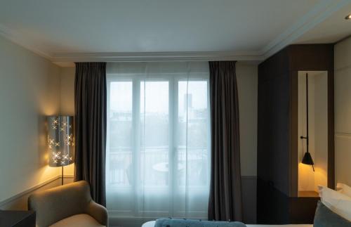 Un ou plusieurs lits dans un hébergement de l'établissement Hotel Villa Saxe Eiffel