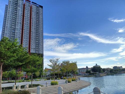 a large building next to a body of water at Wallaway2stay Gravit8 Andaman Klang 2 Queen Room in Klang